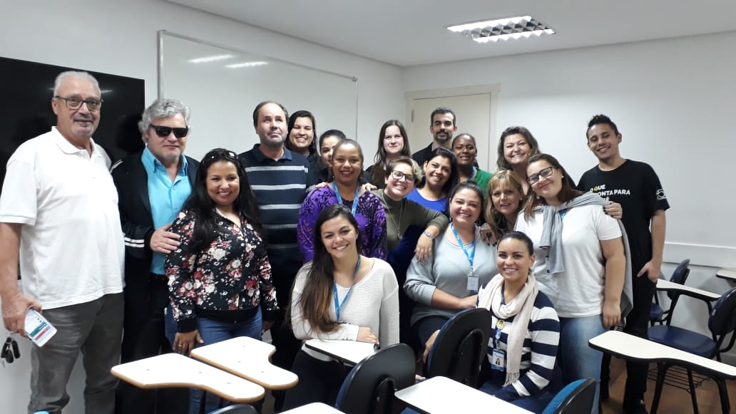 Equipe da ADEVIC e da FUNDATEC posam sorrindo para uma foto na sala de aula